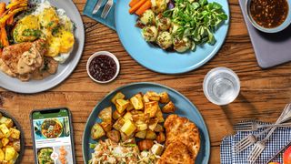 a meal laid out with on a wooden dining table made from a Hello Fresh meal kit