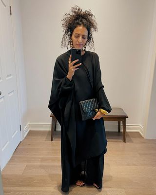 Influencer Neelam Ahooja wearing a wrap black dress