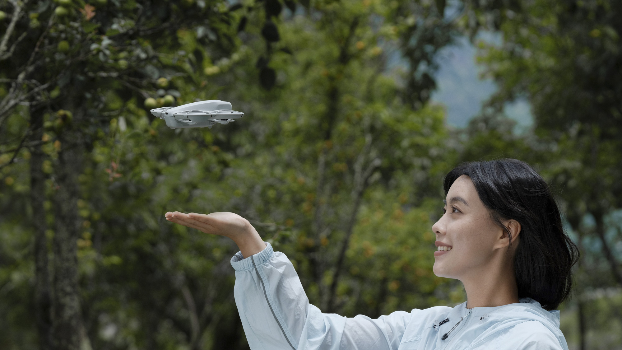 The DJI Neo drone takes off from a person's hand