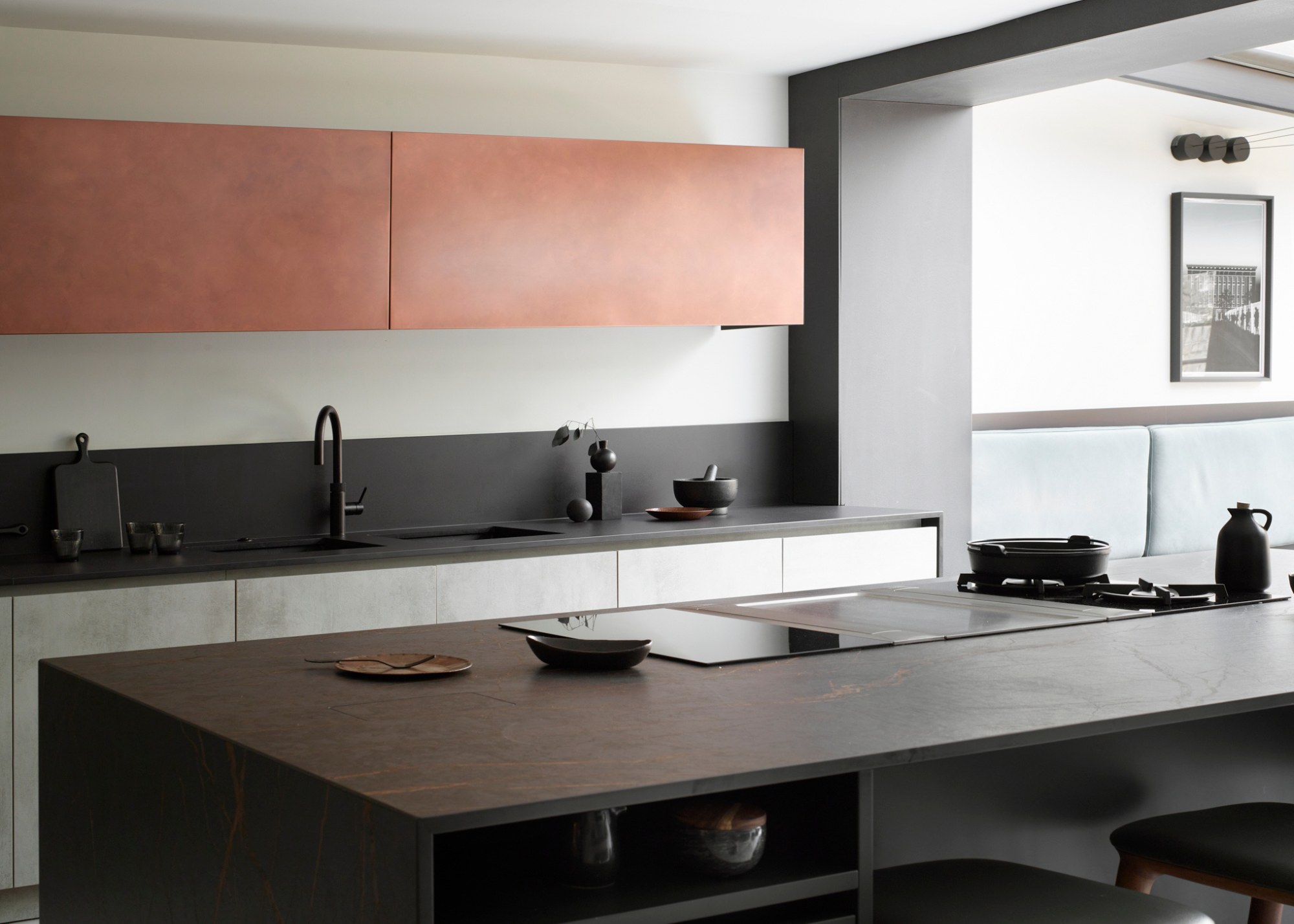 modern kitchen with black porcelain counters and red overhead cabinets