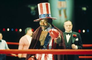 Apollo Creed (Carl Weathers) points to the audience from the ring dressed as Uncle Sam in Rocky