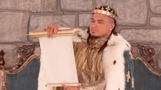 Keanu dressed as a king, holding a scroll in Big Brother Season 28