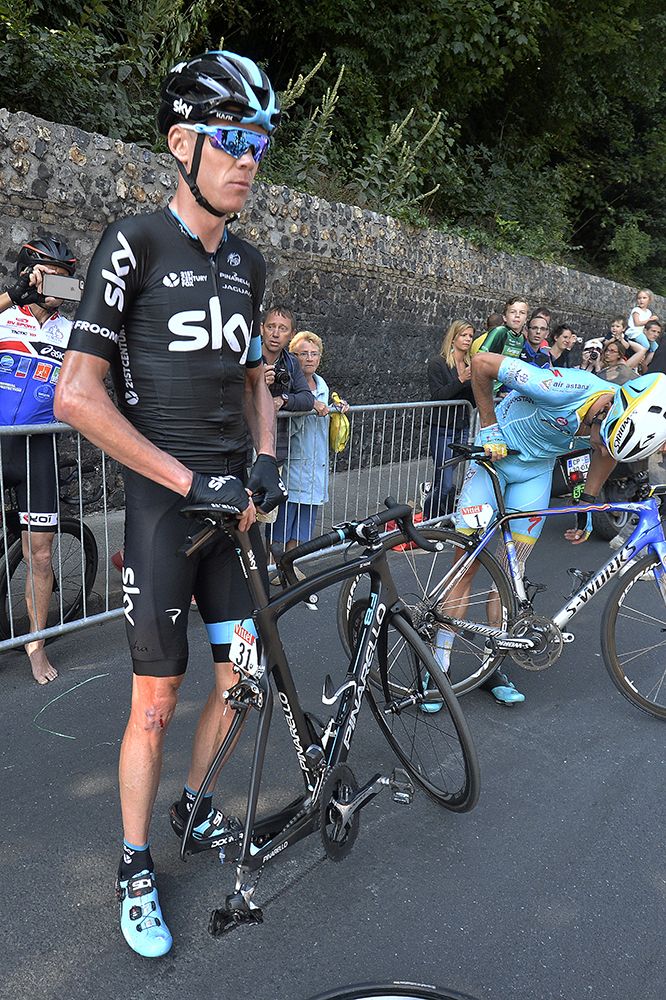 Chris Froome (Sky) waits for a spare wheel