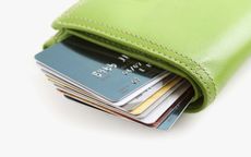 Green Leather Wallet Stuffed with Credit Cards. Carrying too much credit.