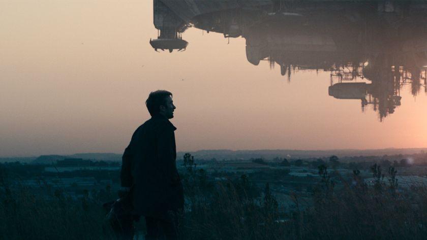 A man looks out at an alien spaceship in the movie District 9