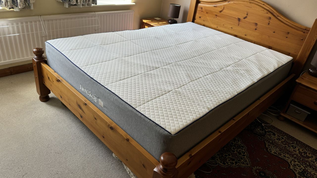 Nectar Hybrid mattress fully-formed on our tester's wooden bed base