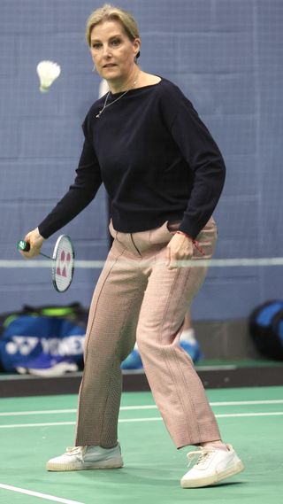 Sophie, Duchess of Edinburgh hits the shuttlecock as she takes part in a badminton match during a visit to the All England Open Badminton Championships