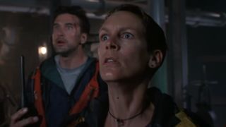 William Baldwin and Jamie Lee Curtis looking horrified in a hallway in Virus.