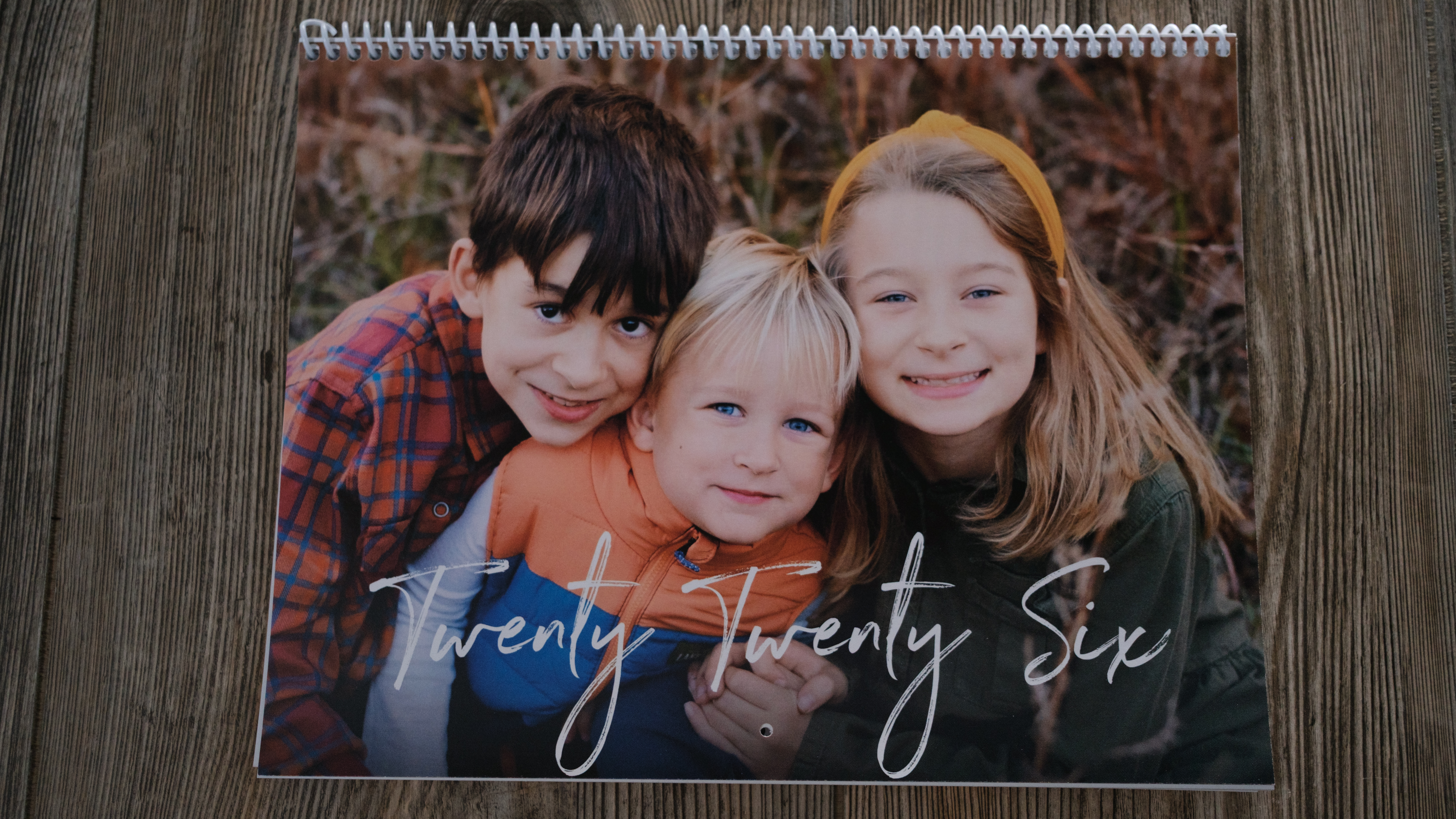 A photo calendar from Nations Photo Lab on a wood background