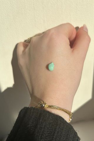 A blob of Rosalique 3-in-1 Anti-Redness Miracle Formula on the back of Tori's hand