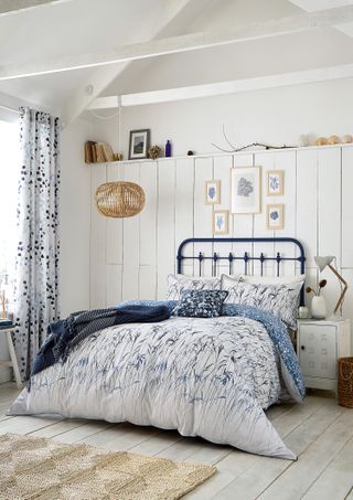 The French Bedroom Company bedroom with a white colour scheme and blue curtains