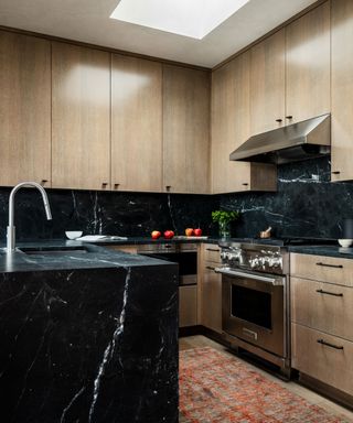 Wooden kitchen with black marble backsplash