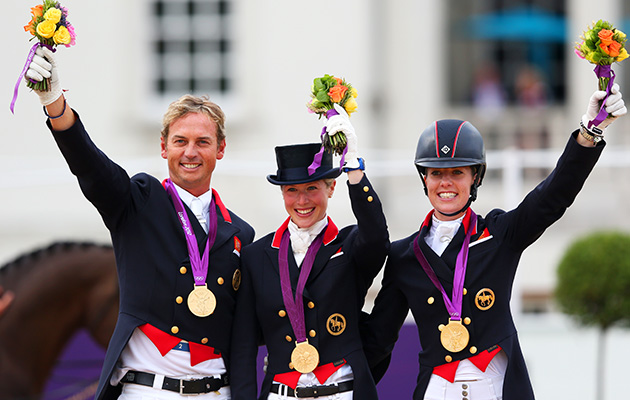 LONDON, ENGLAND - AUGUST 07: (L-R) Carl Hester, Laura Bechtolsheimer and Charlotte Dujardin of Great Britain celebrate with their gold medals during the medal cerermony for the Team Dressage on Day 11 of the London 2012 Olympic Games at Greenwich Park on August 7, 2012 in London, England. (Photo by Alex Livesey/Getty Images)
