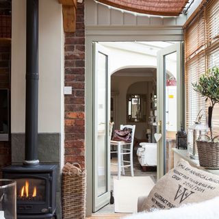 conservatory with fireplace and glass door