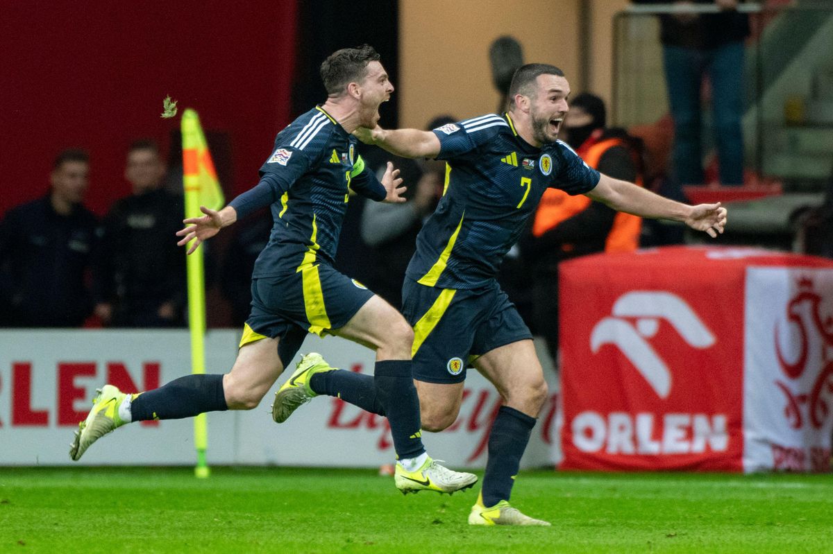 Andy Robertson celebrates with John McGinn after scoring Scotland&#039;s winning goal in stoppage time against Poland in the Nations League in Warsaw, November 2024