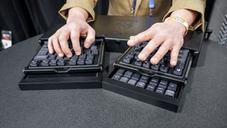 A person typing on the AutoKeybo and then switching to a different peripheral at CES