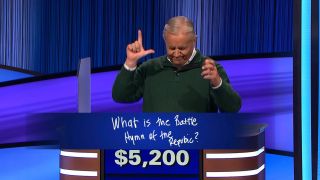 Contestant Brian making L with hands while losing Jeopardy
