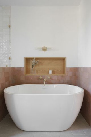 a tiled bathroom with a wood niche