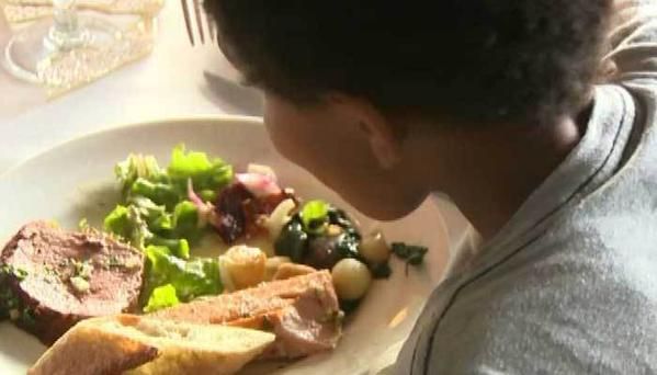 A child eats a meal donated by a woman whose wedding was called off.