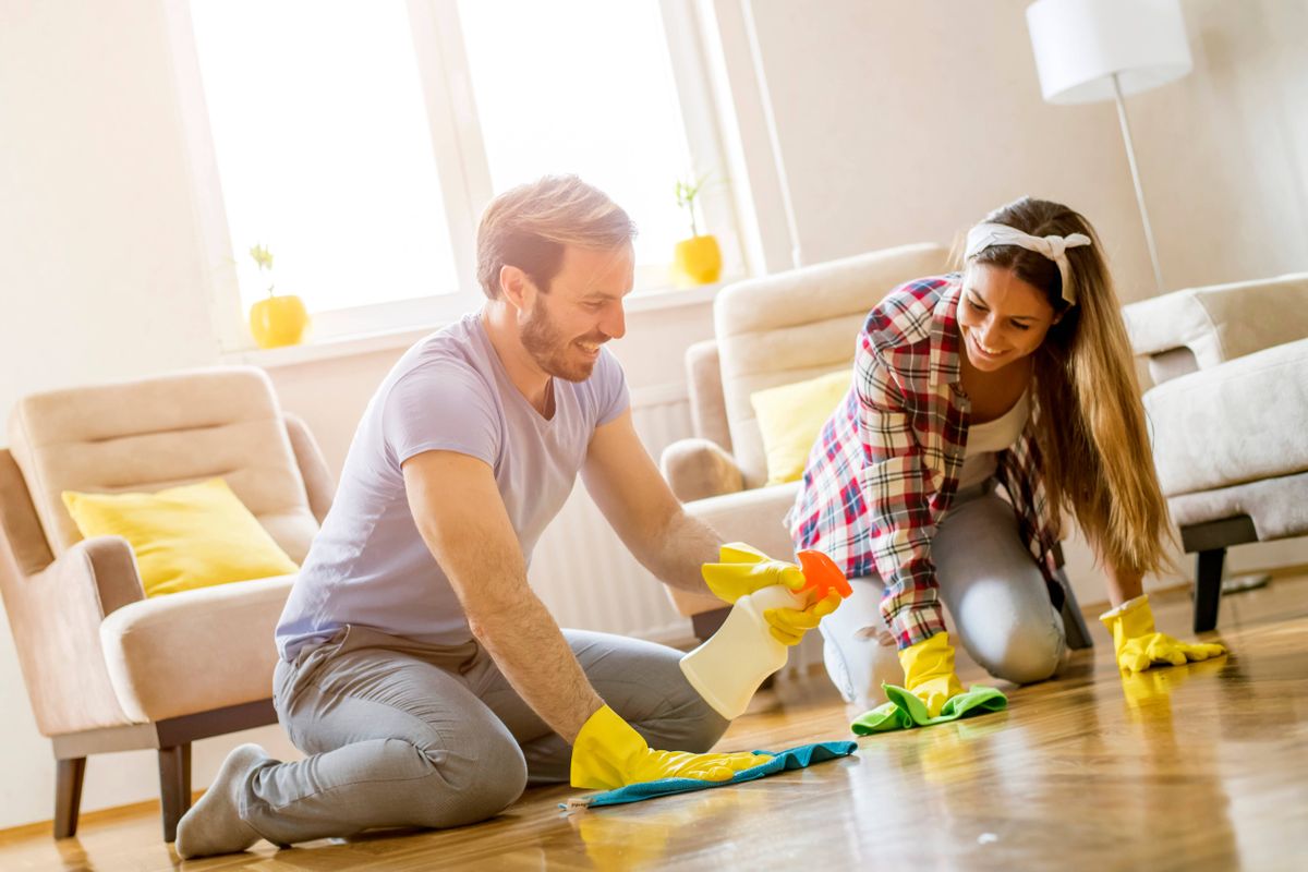 Young couple doing their spring cleaning