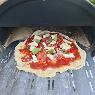 Putting a pizza into the Gozney Roccbox