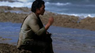 Daniel Dae Kim as Jin, sitting on the shore, fishing in Lost