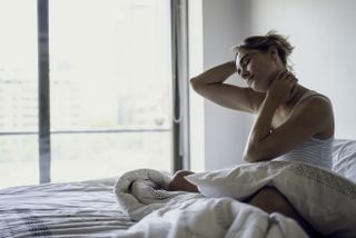 Young woman waking up in the morning after having a nightmare