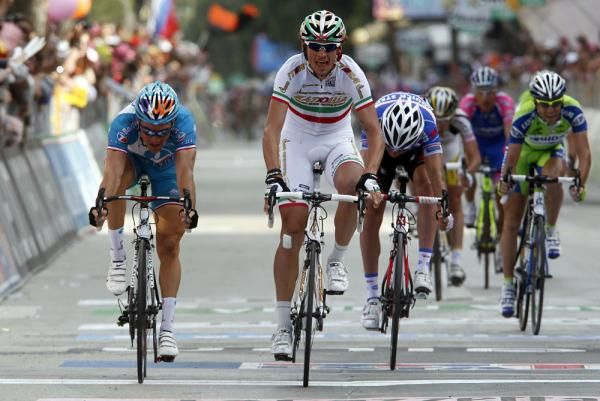 Pozzato lifts his hands off the handlebars and gets ready to celebrate