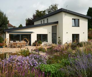 exterior of a white rendered detached home designed to meet Passivhaus Plus standards