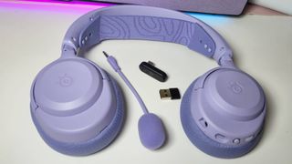 Photo of the SteelSeries Arctis Nova 3 Wireless gaming headset sitting on a white desk.
