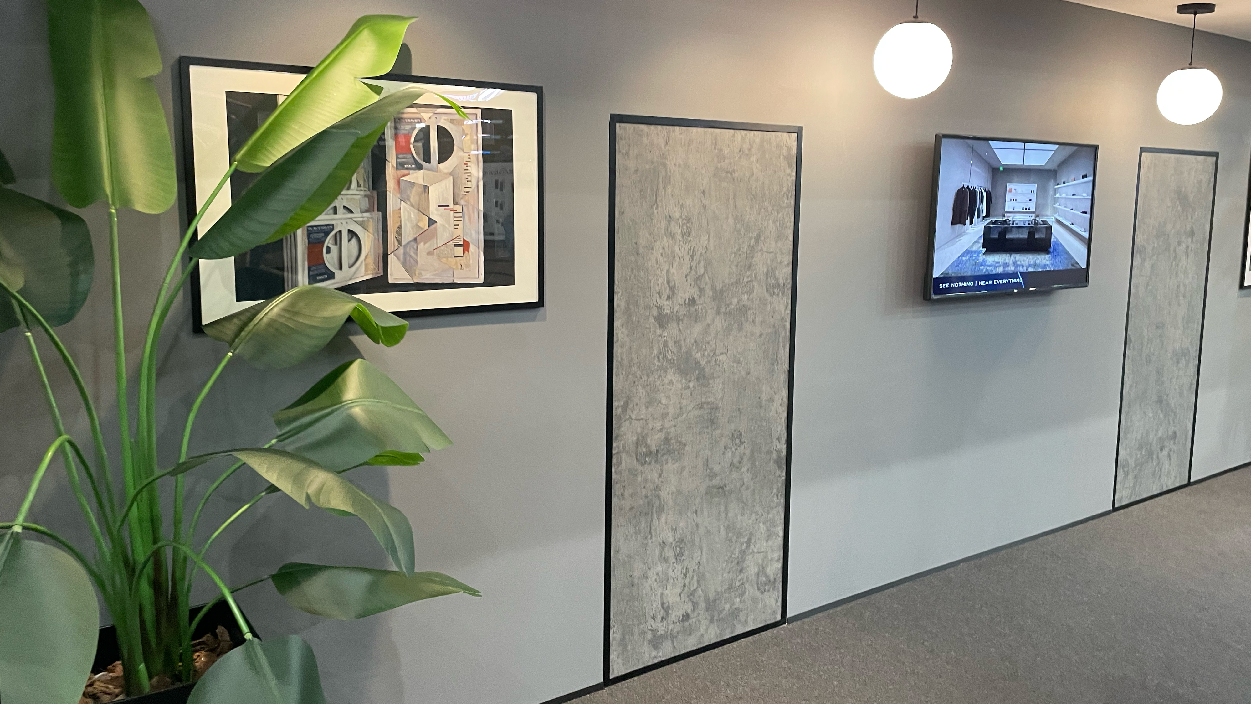 Stealth Acoustics L-RAD range of invisible speakers behind a wall &amp;ndash; there are no obvious speakers, just panels, a display TV and a plant