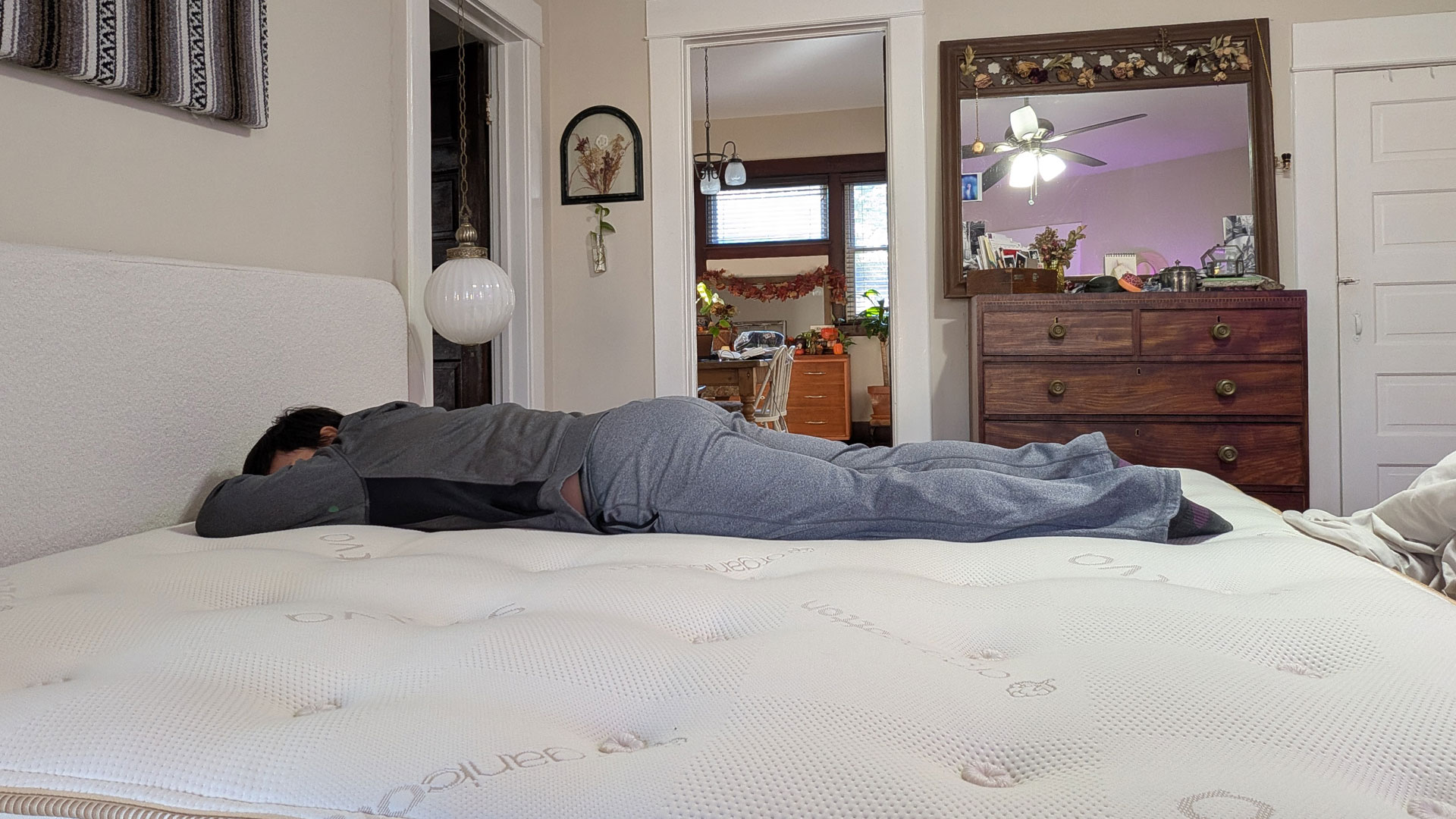 A woman lying on her stomach on the Saatva Latex Hybrid mattress