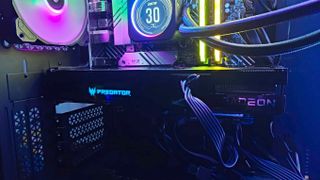 AMD Radeon RX 7600 graphics card inside PC next to RGB fans and AIO cooler