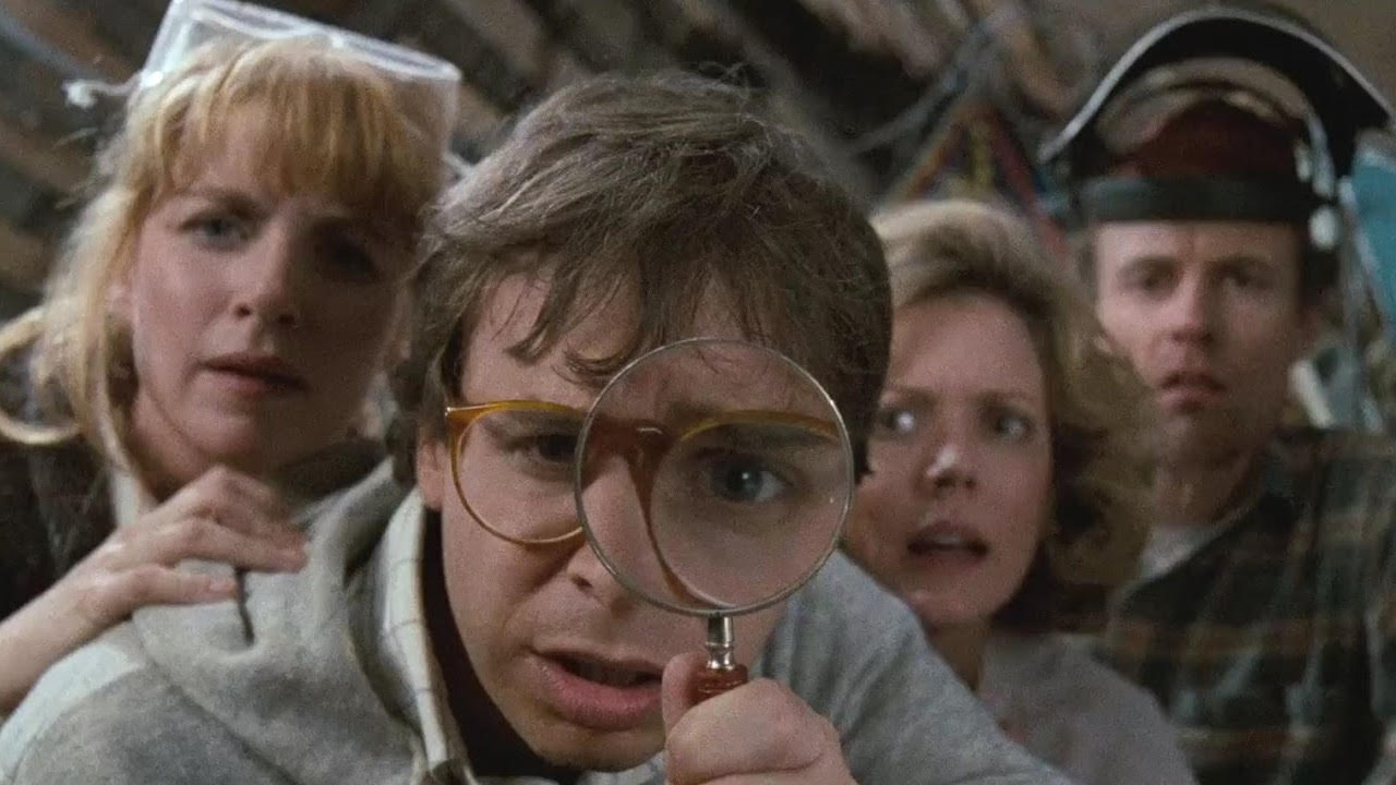 Rick Moranis with a magnifying glass