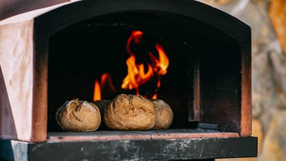 bread rolls cooking in pizza oven