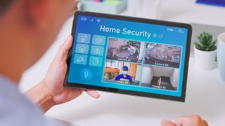 security camera system - close up back view of asian businessman uses home security camera system on digital tablet in the office when delivery man is coming