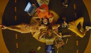 Assassination Nation the girls lay down in a circle on a comfy cushion