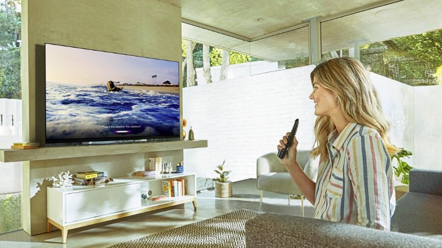 Woman holding remote in front of TV