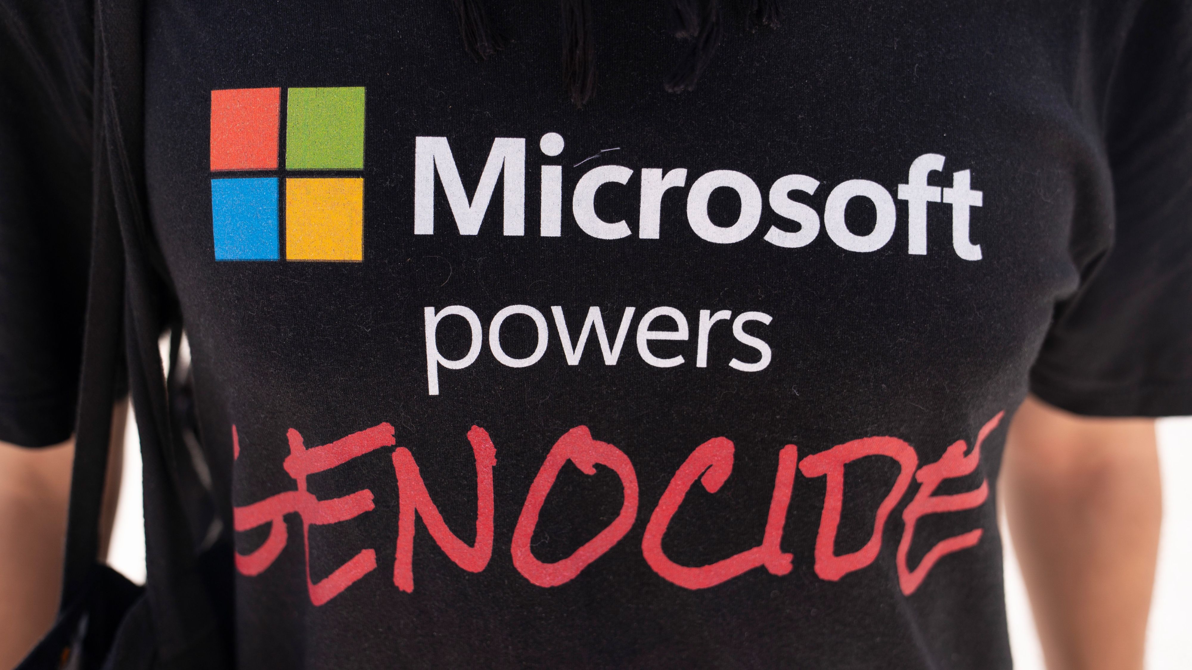 A demonstrator wears a shirt reading "Microsoft Powers Genocide" during a protest at the Microsoft Campus in Redmond, Washington, US, on Tuesday, Aug. 19, 2025.