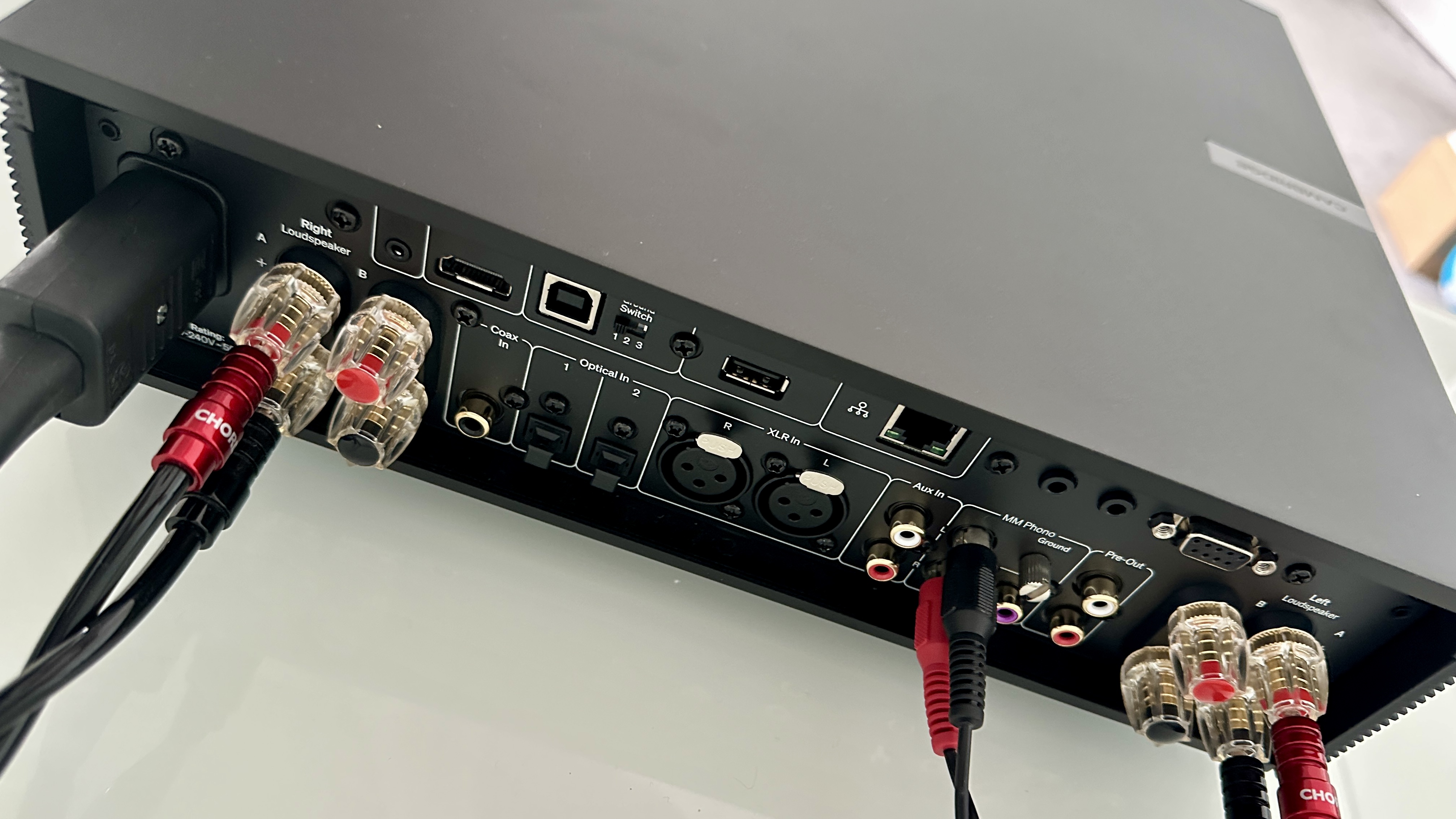 The Cambridge Evo 150 SE on a gray hi-fi rack, showing the color screen, grilles and ports