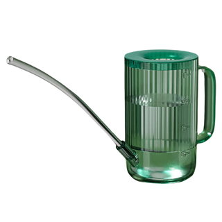 A clear green small watering can