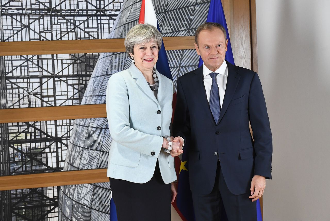 Theresa May shakes hands with Donald Tusk