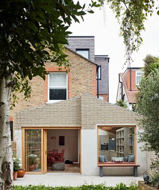 a pitched roof rear extension with a pale brick and render finish