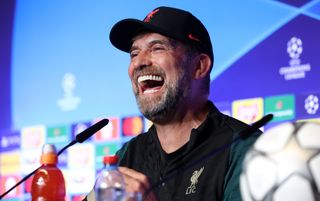 Liverpool manager Jurgen Klopp laughing in a press conference before the 2022 Champions League final against Real Madrid