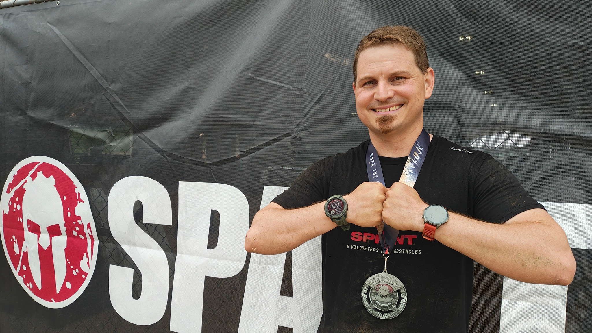 Wearing an Amazfit Balance 2 and a Garmin Instinct 2X Solar smartwatch at a Spartan Race