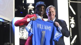 Jameson Williams poses with NFL Commissioner Roger Goodell onstage after being selected 12th by the Detroit Lions during round one of the 2022 NFL Draft on April 28, 2022 in Las Vegas, Nevada.