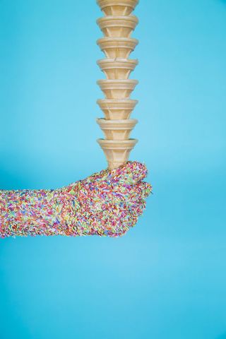 Pictured: Hand of cake sprinkles holding cones