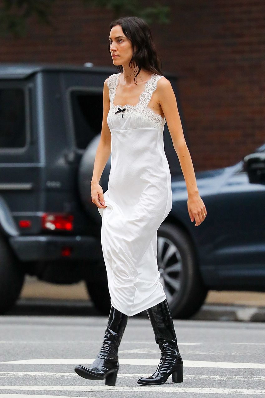 Alexa Chung wearing a white maxi dress with patent leather knee boots in NYC