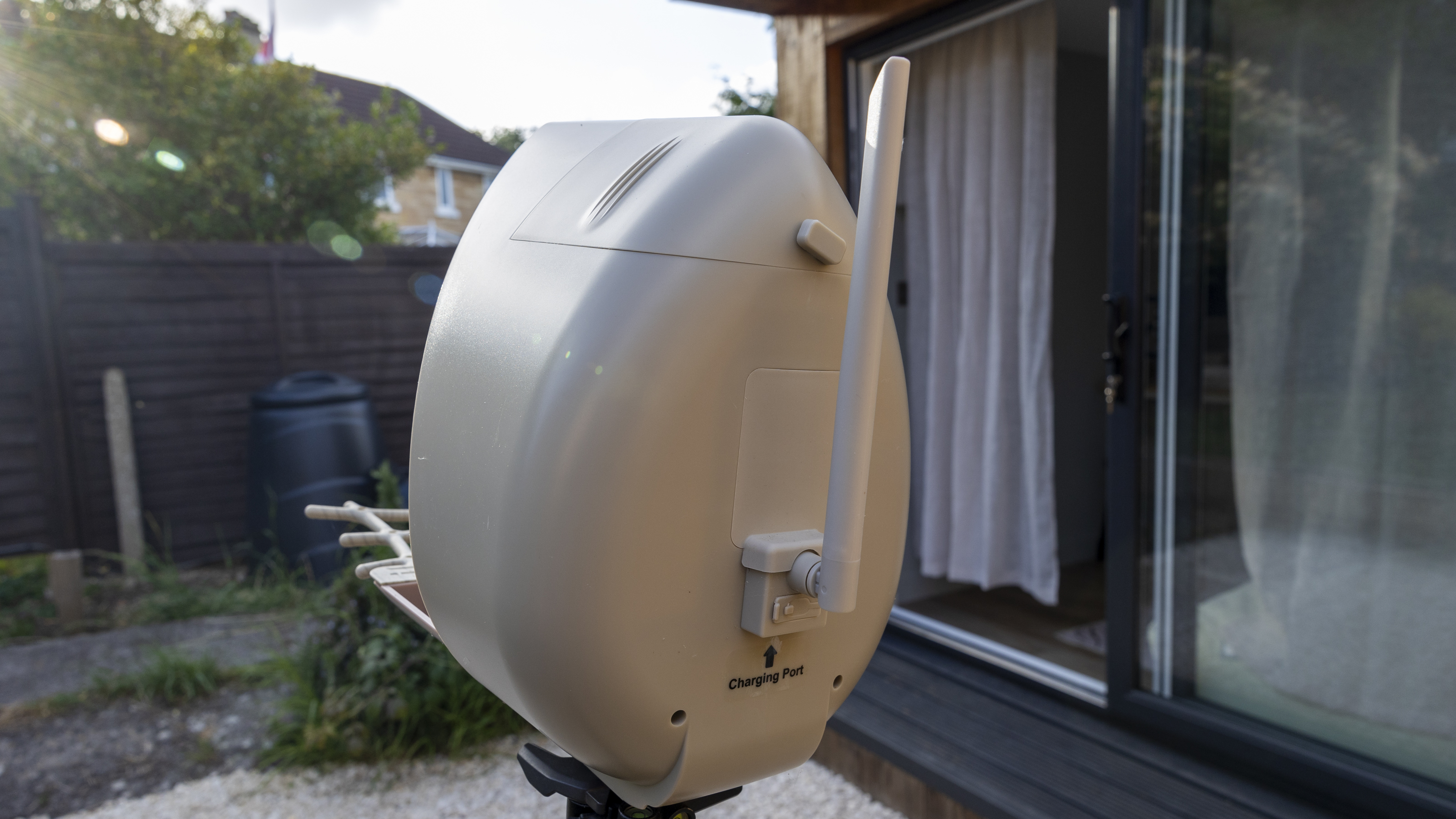 The PeckPerk bird feeder on a tripod in a small English garden