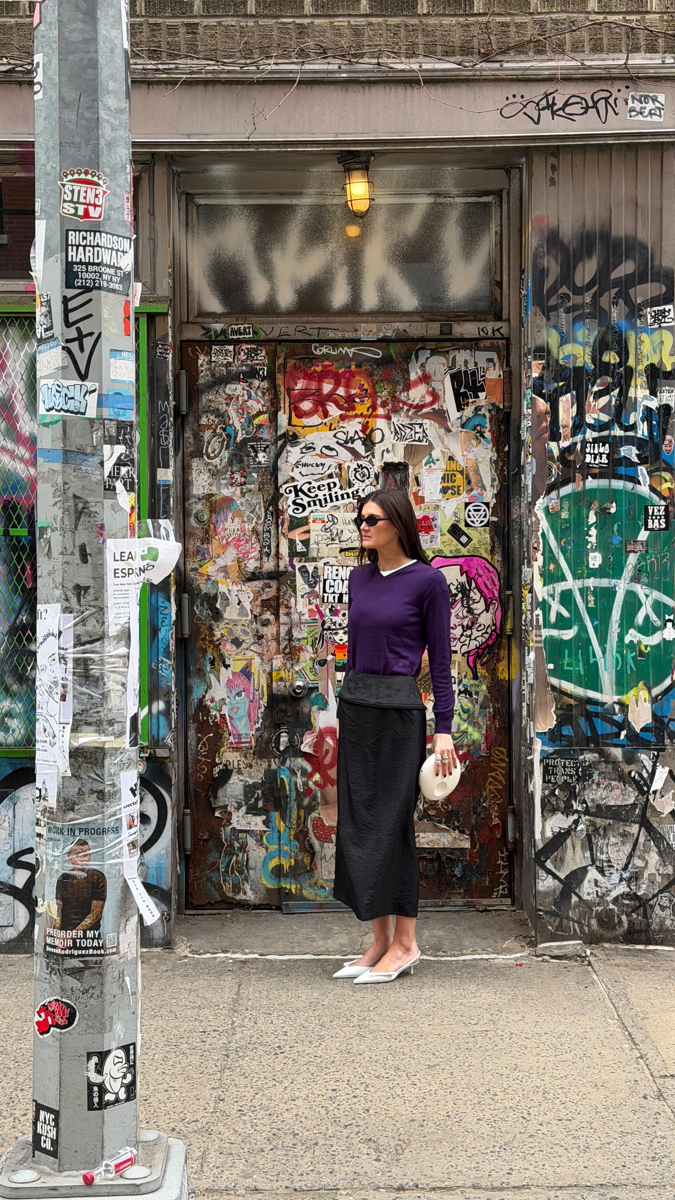 Coco Schiffer wearing a royal purple sweater.